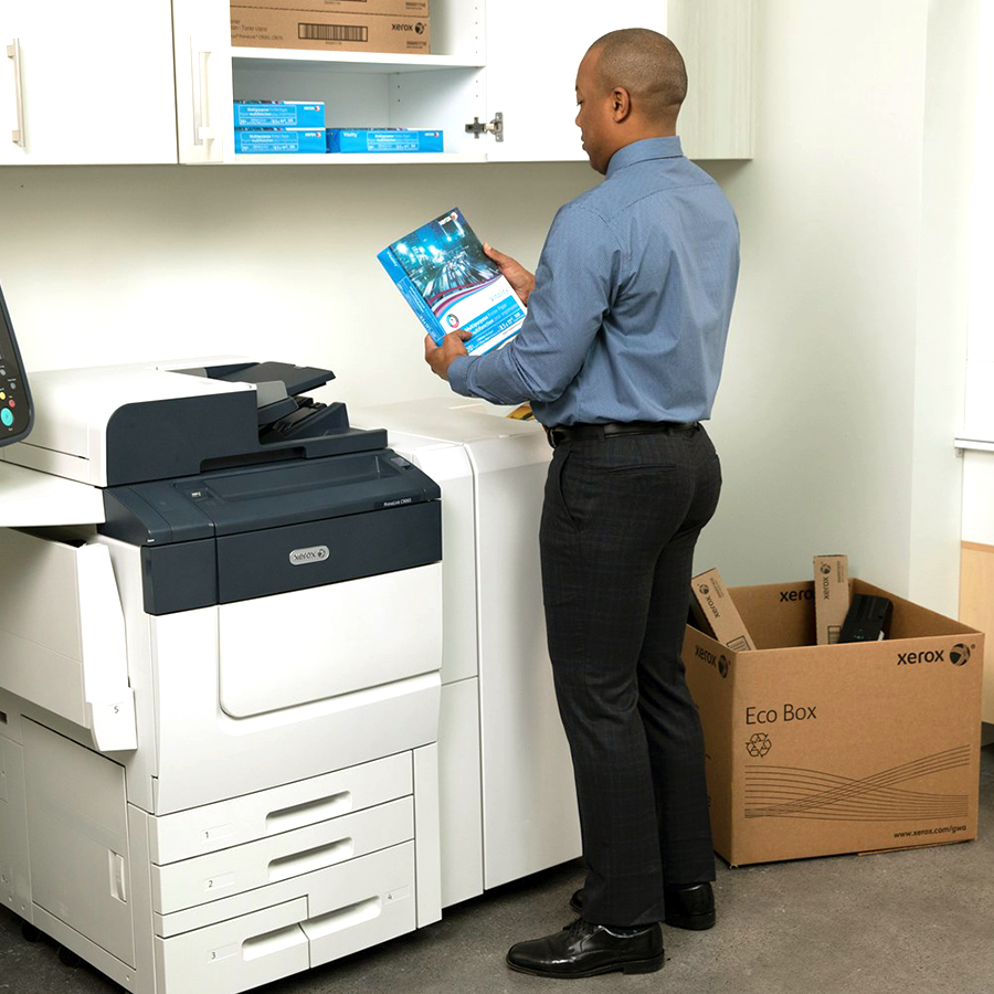 homme qui utilise une ecobox devant une imprimante xerox